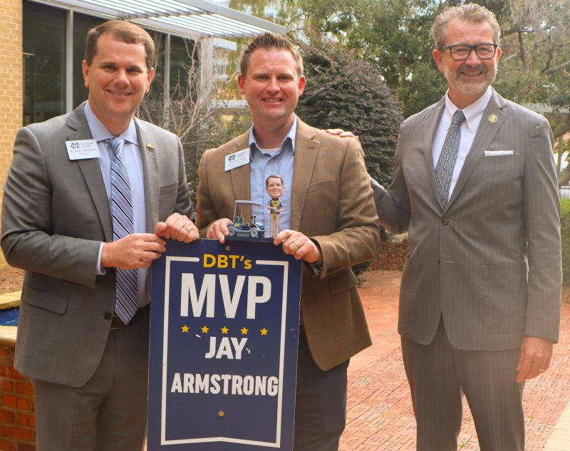 Mississippi College President Blake Thompson, left, presents his DBT's MVP Award for November to Jay Armstrong, center, while MC Law Dean John Anderson observes.